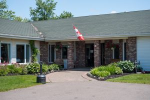 Whisperwood Villa front entrance with gardens and flag