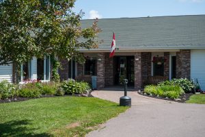 Whisperwood Villa front entrance with gardens and flag